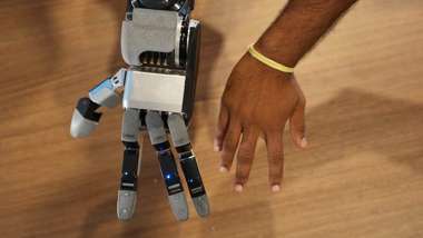 Boston Dynamics' new four-fingered Atlas hand next to a human hand for scale (Image: Boston Dynamics)