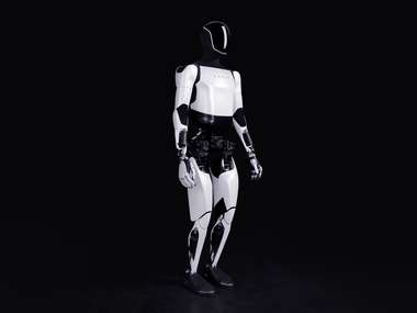 Tesla Optimus humanoid robot standing in a dark studio (Photo: Tesla)